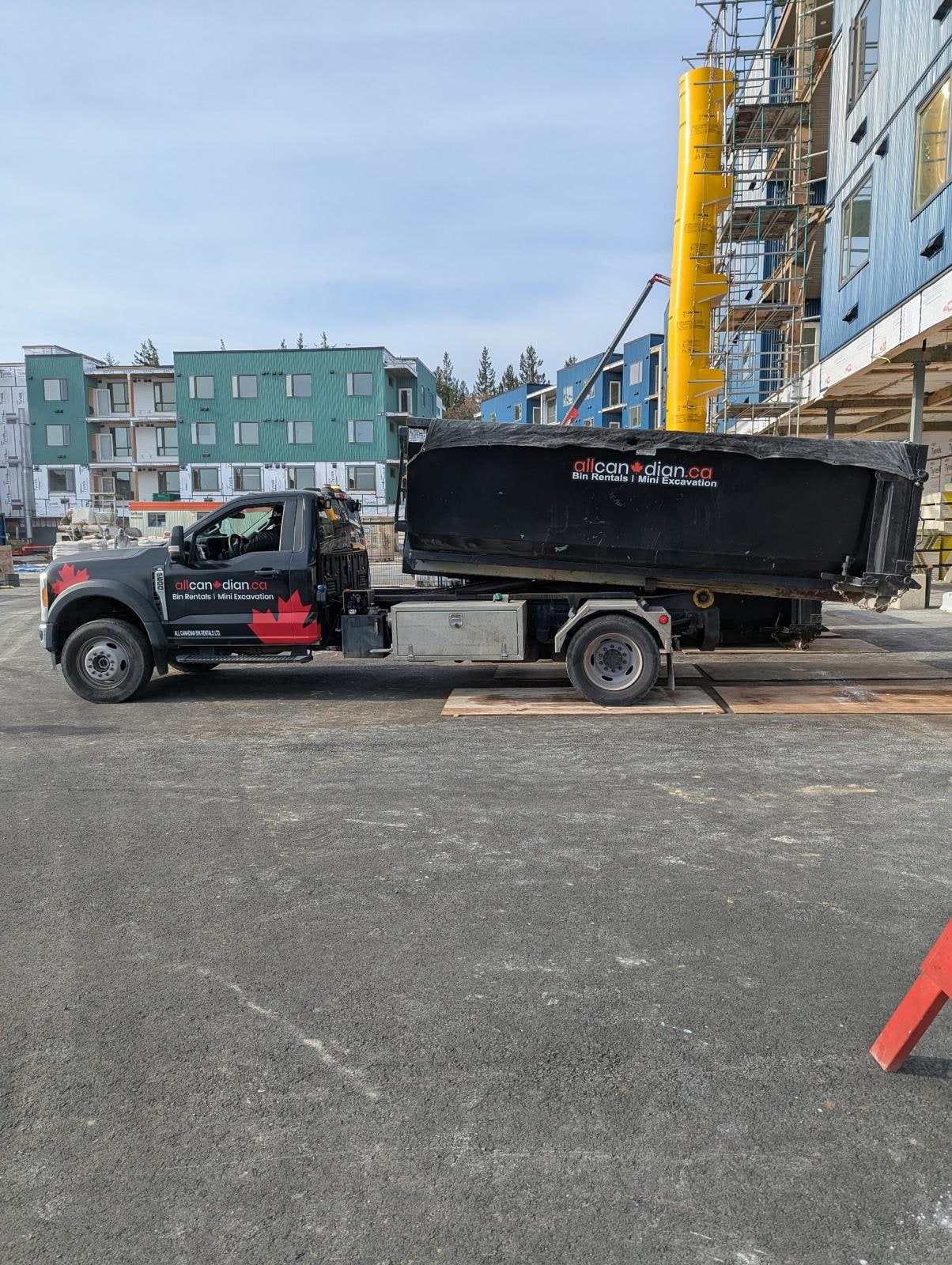 All Canadian debris removal truck on a construction job site