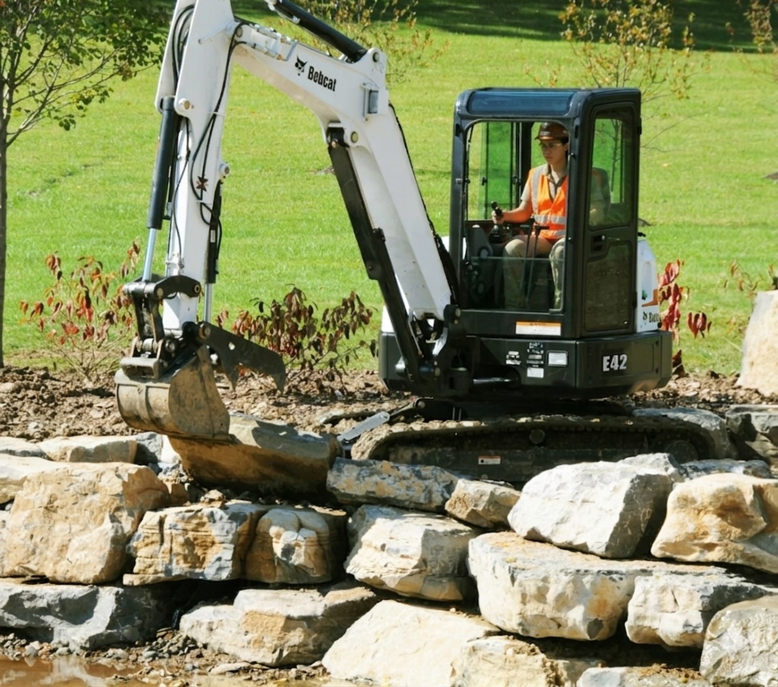 Mini excavator building a retaining wall