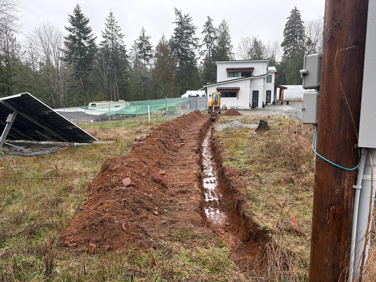 Mini excavator trenching for irrigation and utilities