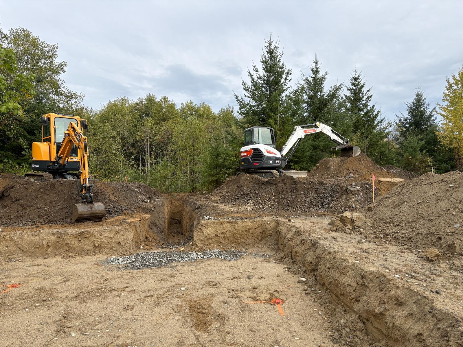 Mini excavator on a site prep land clearing job
