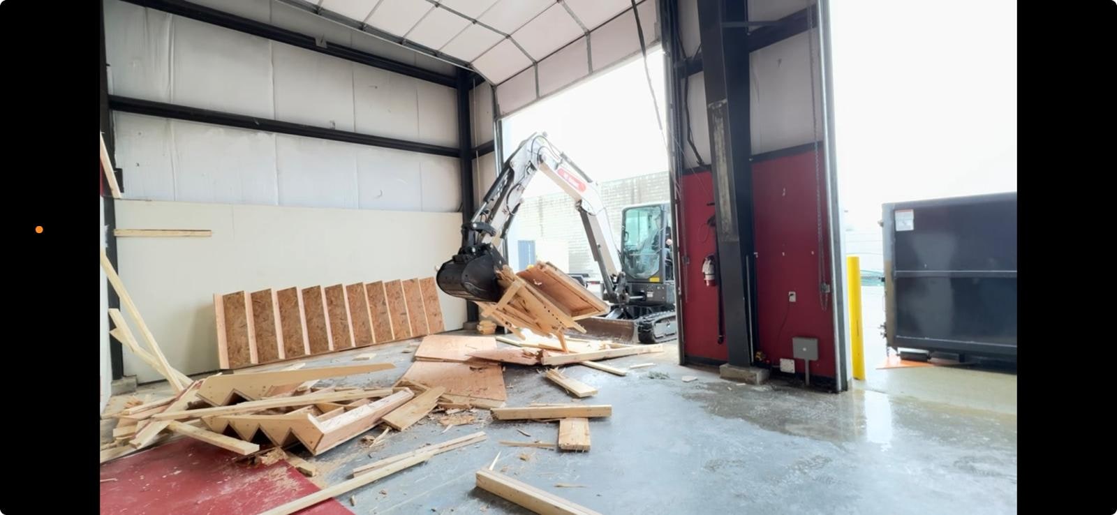 Mini excavator handling small demolition of interior framing